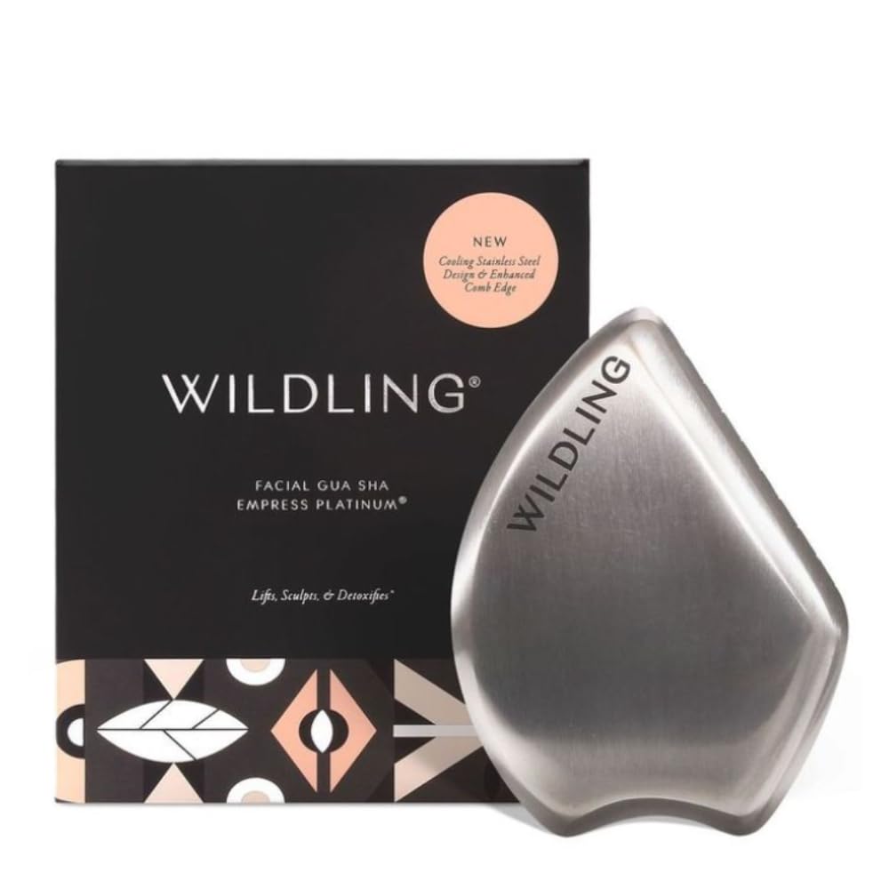 a heavy stainless steel gua sha with sculpted edges in hand
